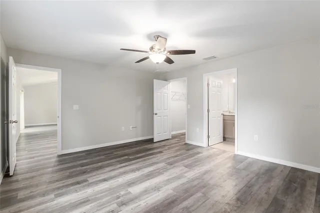 a bathroom with a granite countertop bathtub shower sink vanity and toilet