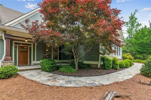 a living room with furniture a wooden floor and next to a window