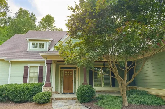 front view of a house with a tree