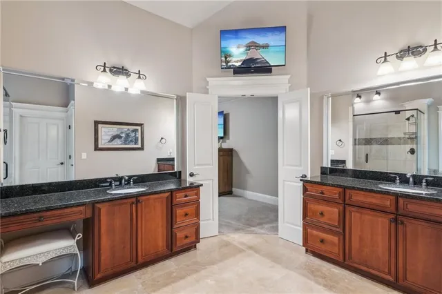 a kitchen with stainless steel appliances granite countertop a sink and a refrigerator