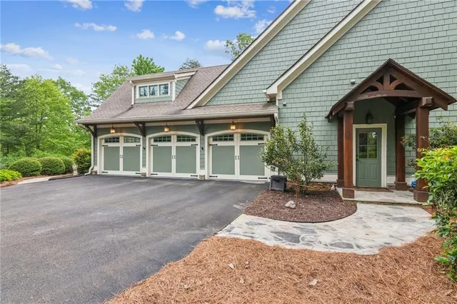a front view of a house with sitting area and garden