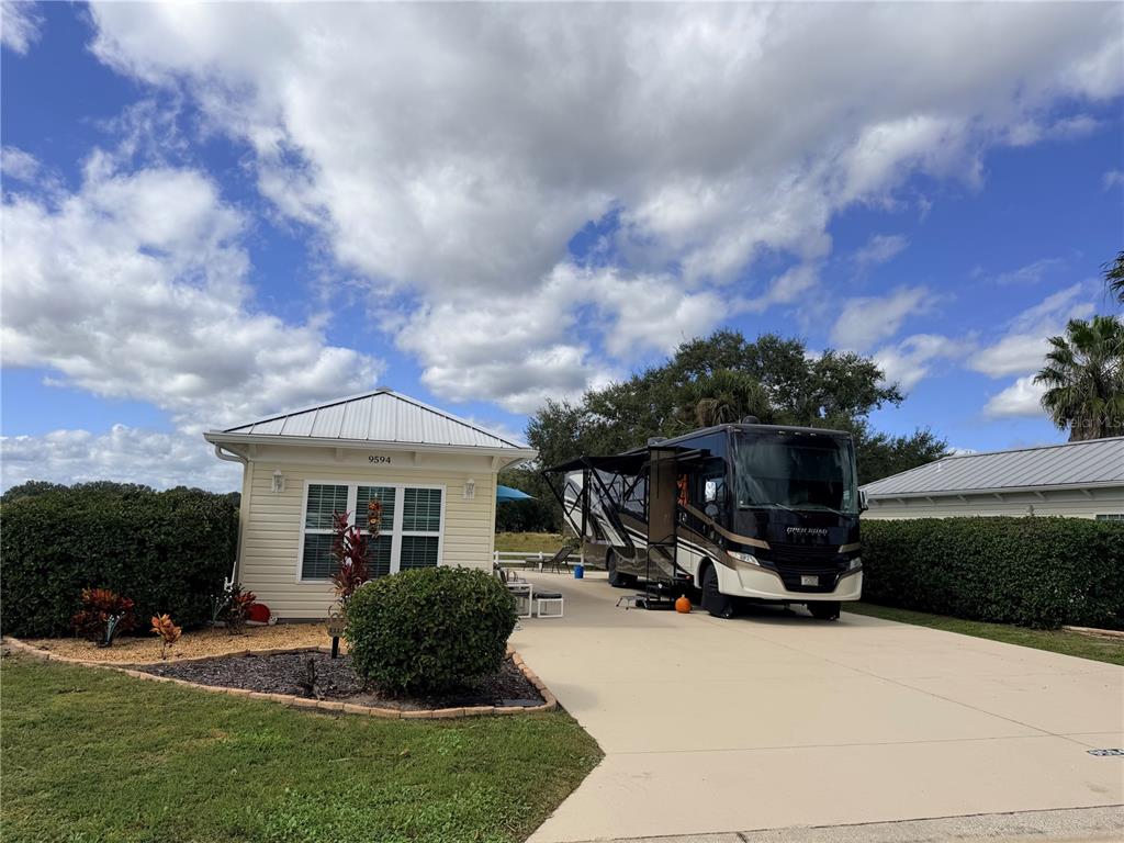 9594 Southeast 47th Way Webster, FL 33597 - Photo 2 of 50 a view of a house with furniture and a fire pit