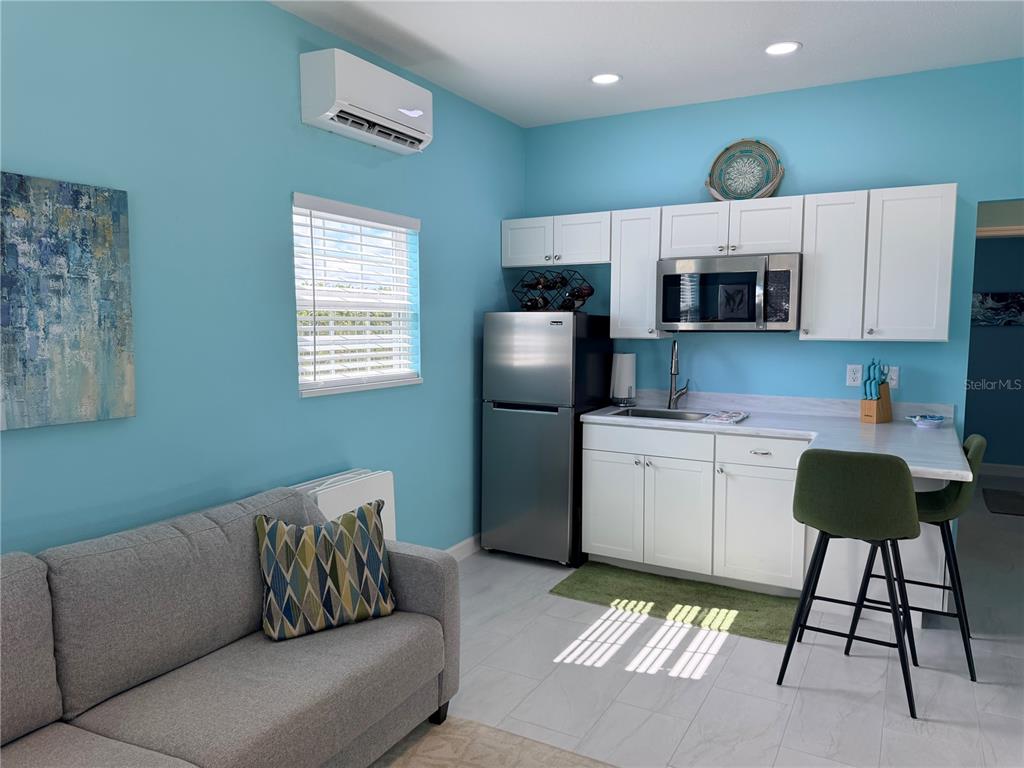 9594 Southeast 47th Way Webster, FL 33597 - Photo 25 of 50 a living room with a couch and a flat screen tv