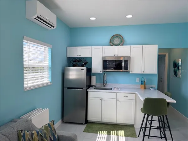 a kitchen with stainless steel appliances a refrigerator sink and microwave