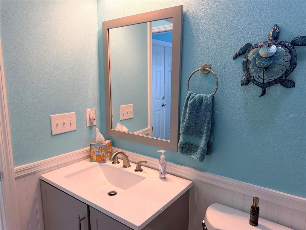 9594 Southeast 47th Way Webster, FL 33597 - Photo 32 of 50 a bathroom with a sink vanity and toilet