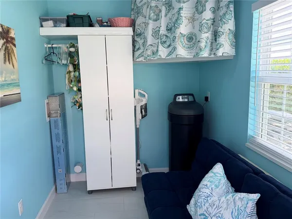 a view of storage and utility room with a window