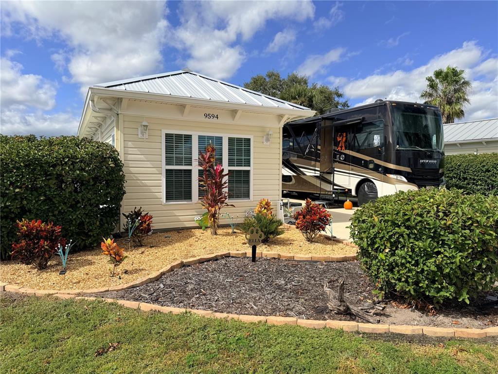 9594 Southeast 47th Way Webster, FL 33597 - Photo 4 of 50 a front view of a house with garden