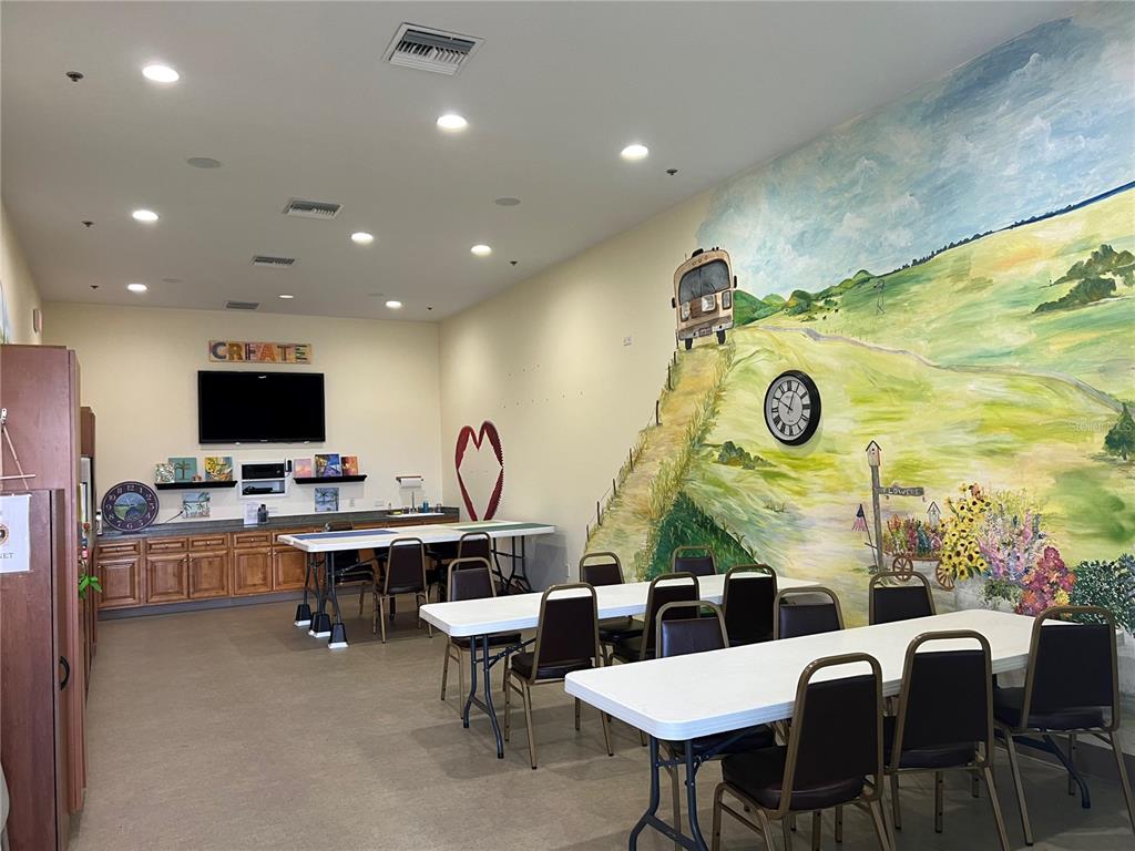 9594 Southeast 47th Way Webster, FL 33597 - Photo 44 of 50 a living room with furniture and a flat screen tv
