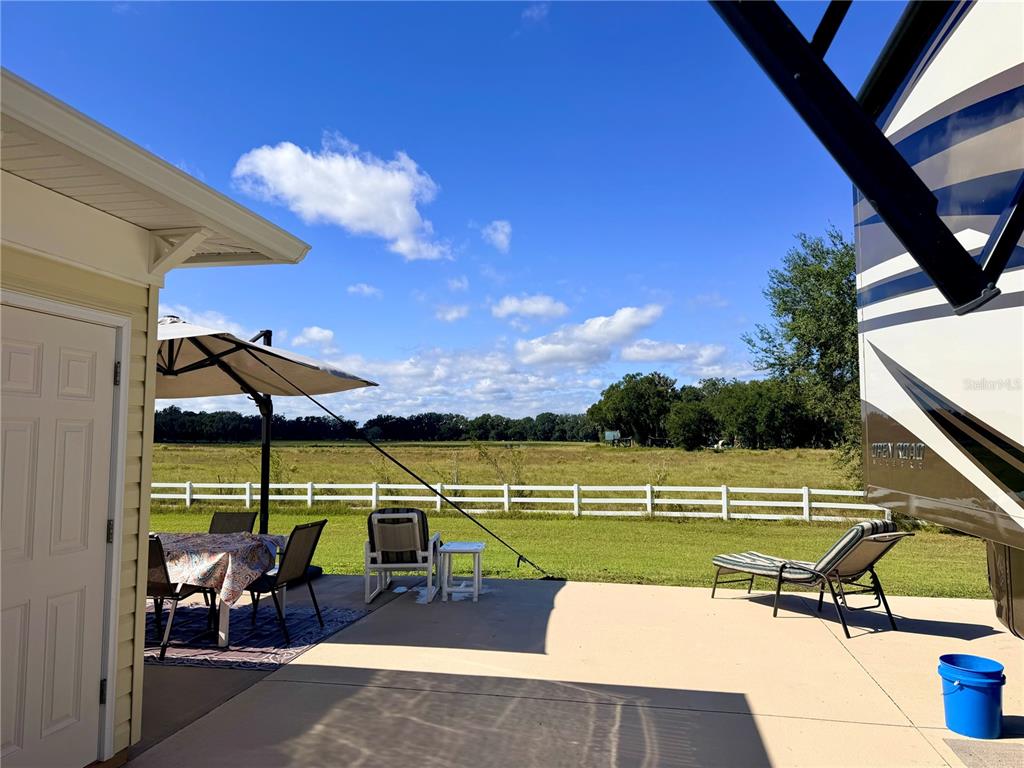 9594 Southeast 47th Way Webster, FL 33597 - Photo 10 of 50 a view of a swimming pool with a lounge chairs