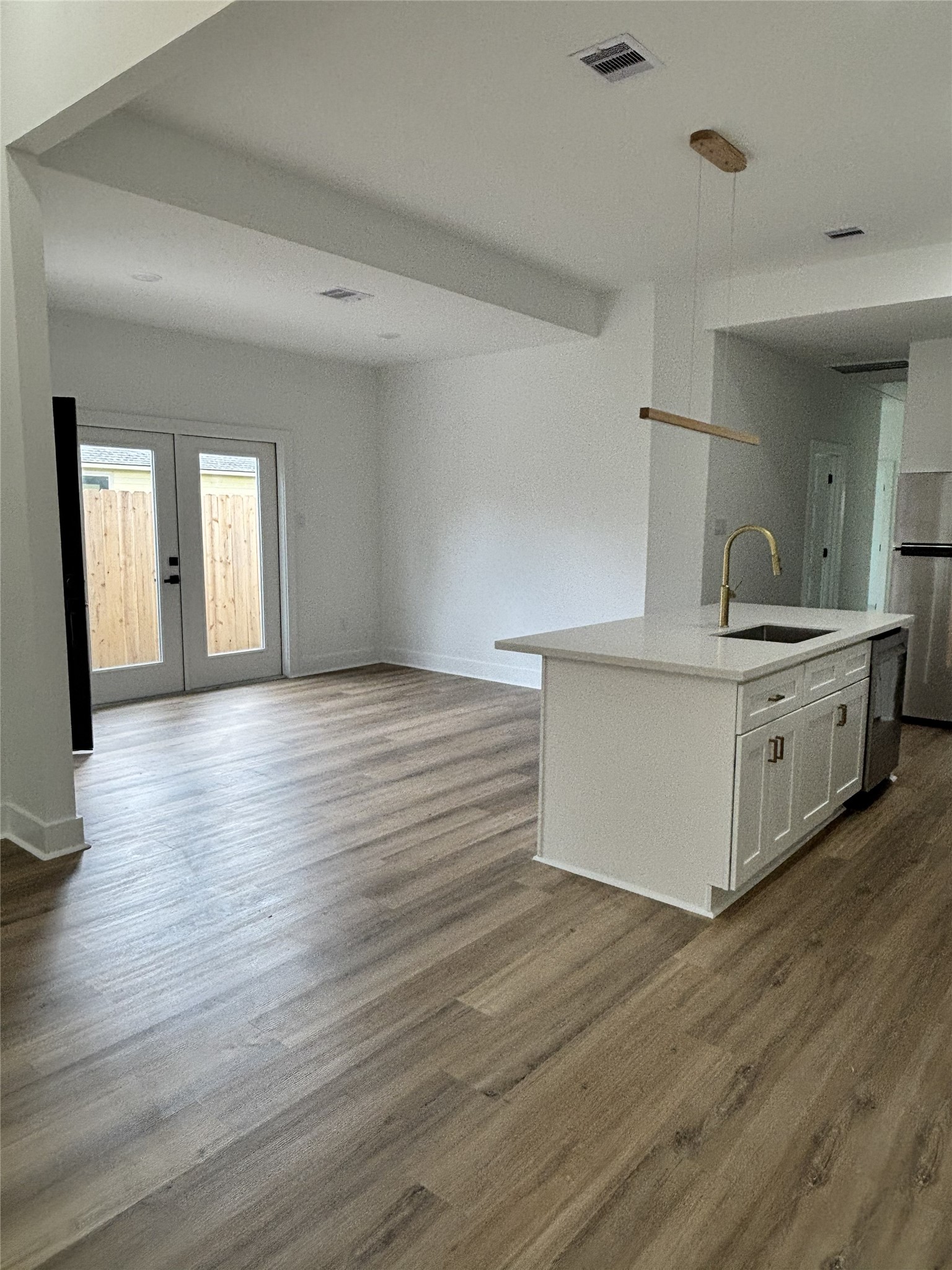 8218 Locksley Road, Unit A/B Houston, TX 77078 - Photo 3 of 11 a view of a kitchen with a sink a refrigerator and wooden floor