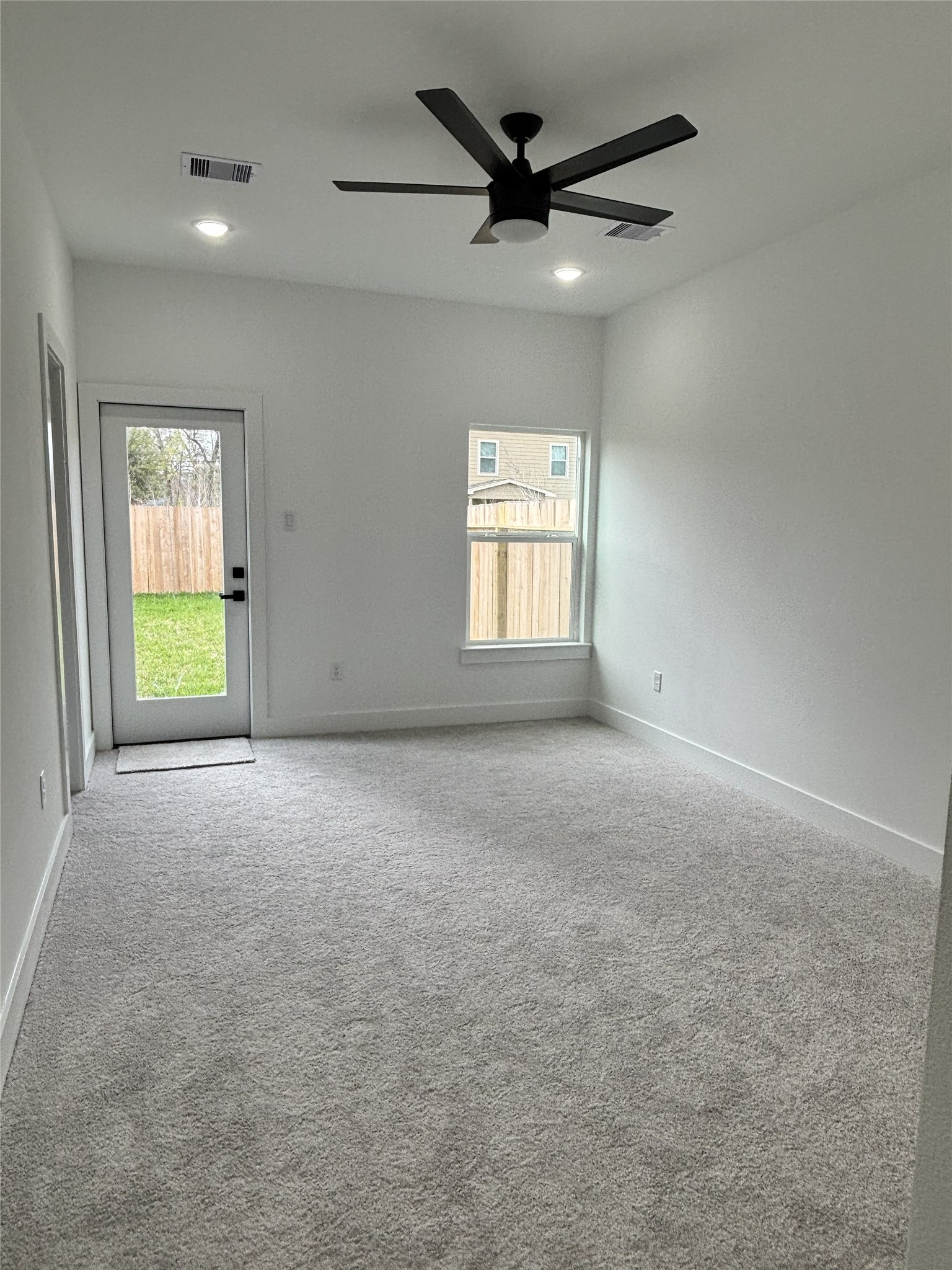 8218 Locksley Road, Unit A/B Houston, TX 77078 - Photo 4 of 11 an empty room with a window and a ceiling fan