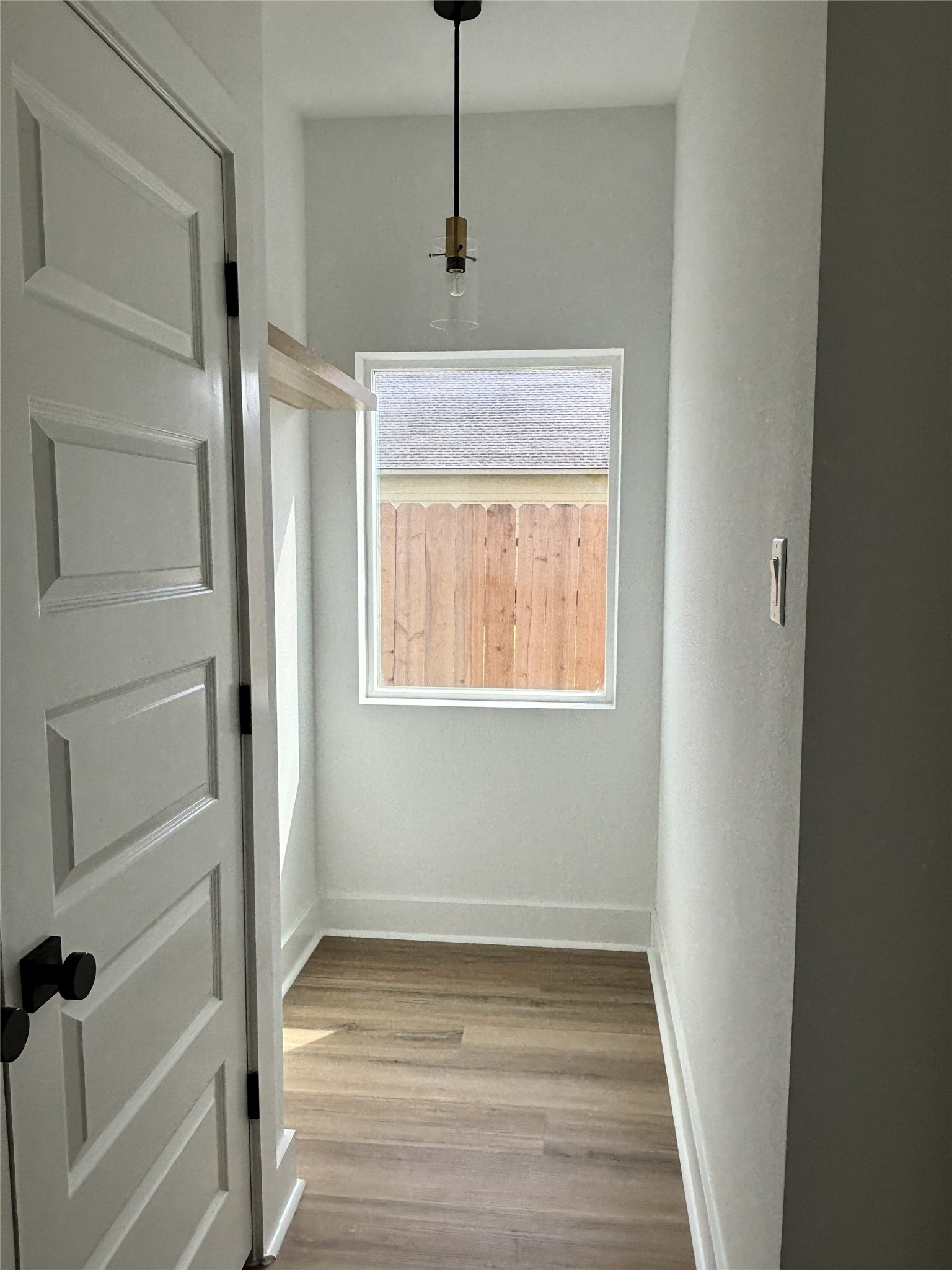 8218 Locksley Road, Unit A/B Houston, TX 77078 - Photo 9 of 11 a view of an empty room with wooden floor and a window