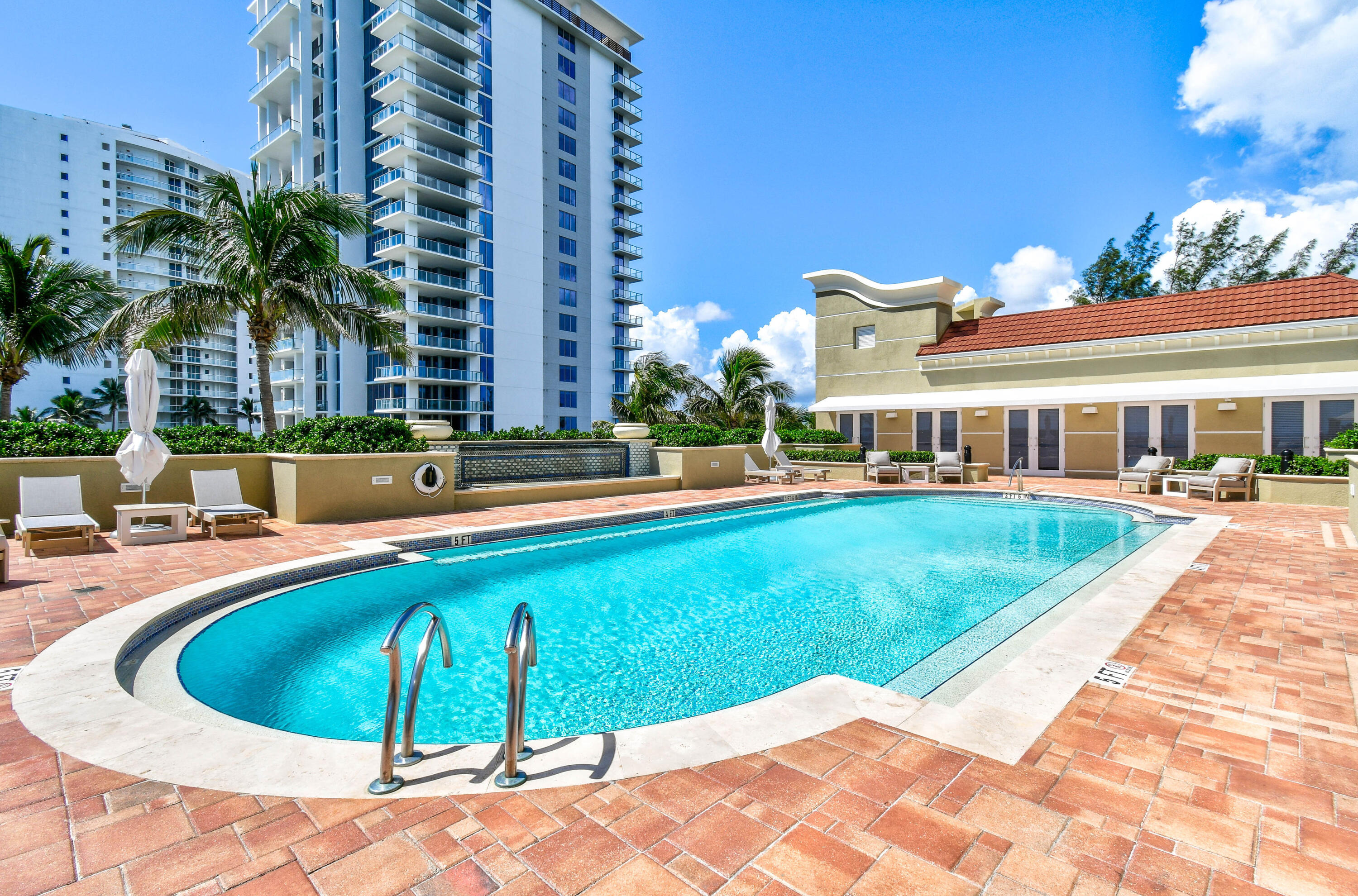5050 North Ocean Drive, Unit 702 Singer Island, FL 33404 - Photo 23 of 40 a view of a house with swimming pool and sitting area