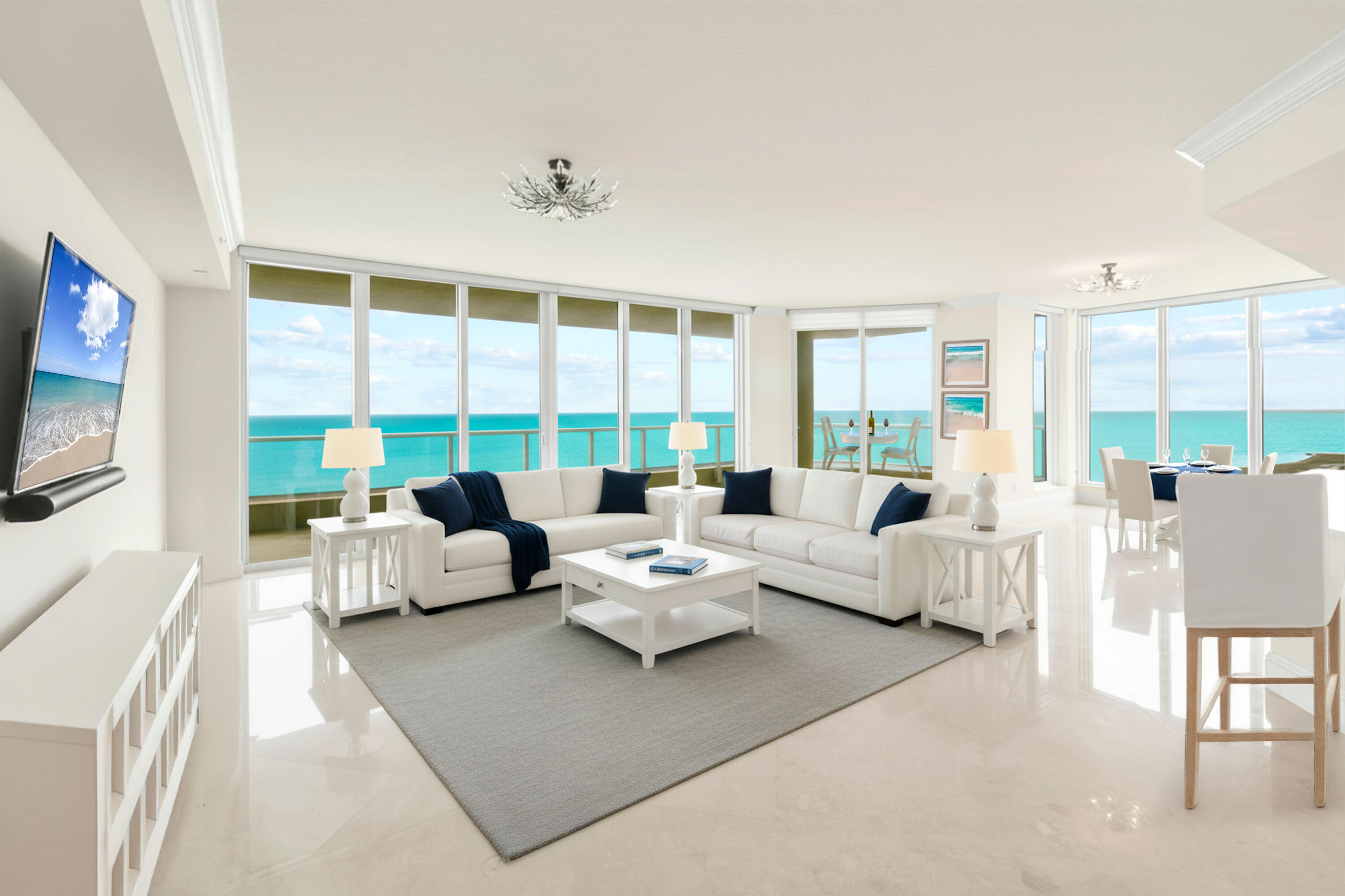 5050 North Ocean Drive, Unit 702 Singer Island, FL 33404 - Photo 3 of 40 a living room with furniture and a flat screen tv