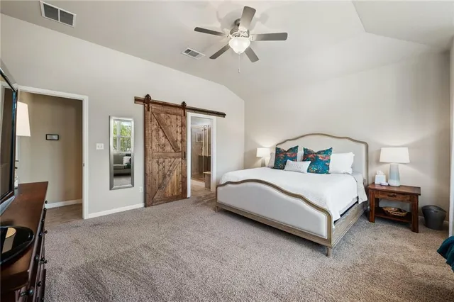 a bedroom with a large bed and a chandelier