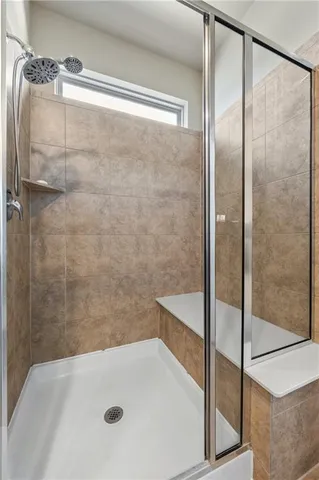 a bathroom with a tub and shower