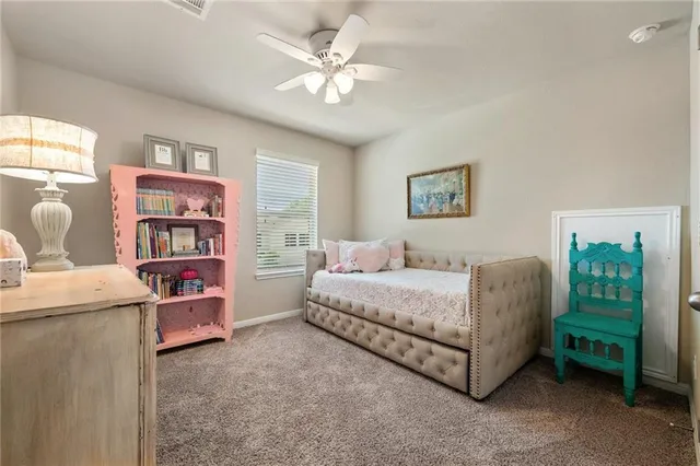 a living room with furniture and a bookshelf
