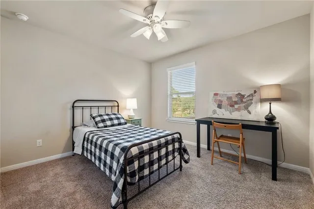 a bedroom with a bed and a table in it