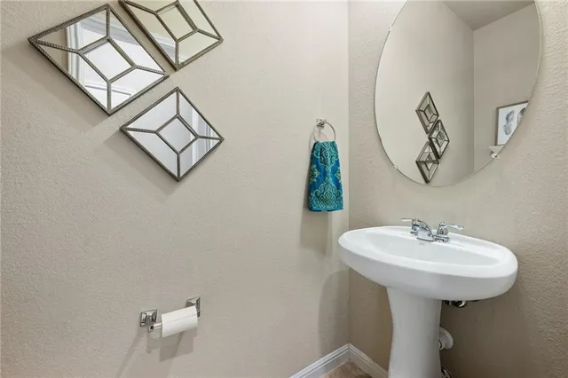 a bathroom with a sink a mirror and vanity