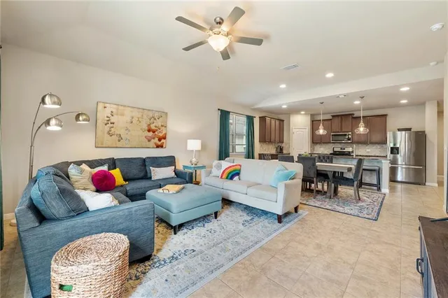a living room with furniture and kitchen view