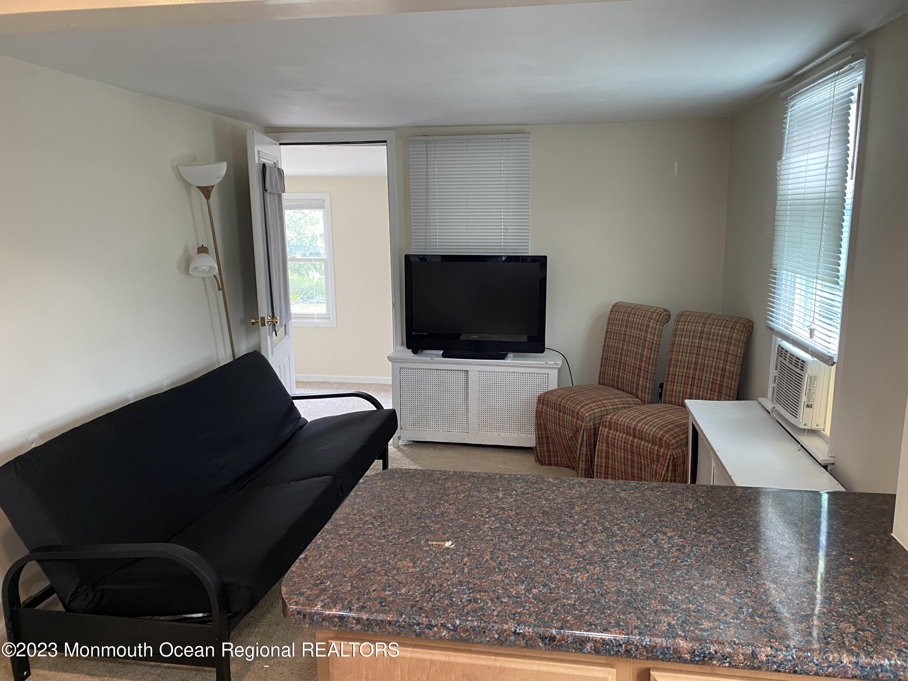 1802 Pine Terrace Lake Como, NJ 07719 - Photo 2 of 9 a living room with furniture and a flat screen tv