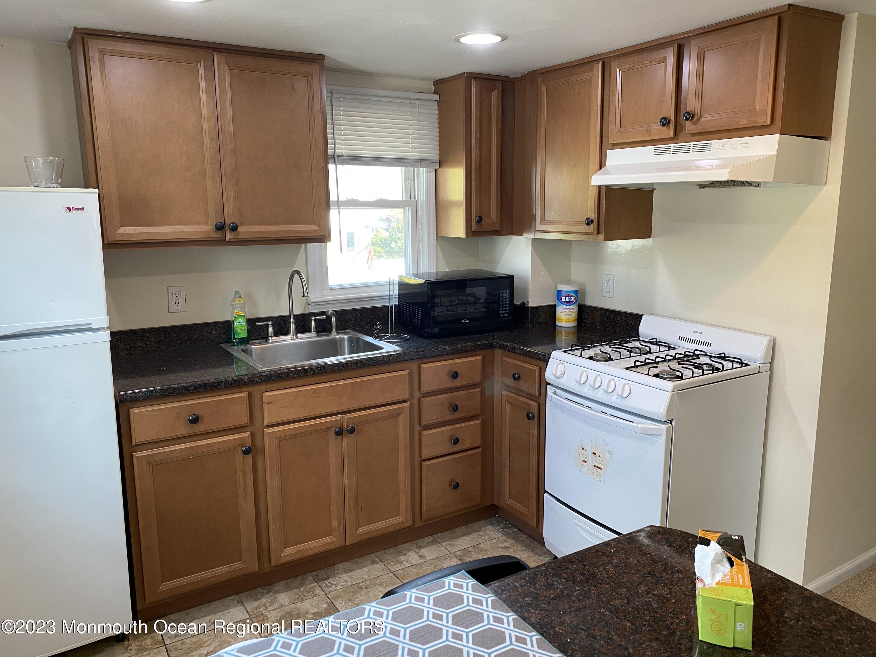 1802 Pine Terrace Lake Como, NJ 07719 - Photo 5 of 9 a kitchen with stainless steel appliances granite countertop a stove a sink and a refrigerator