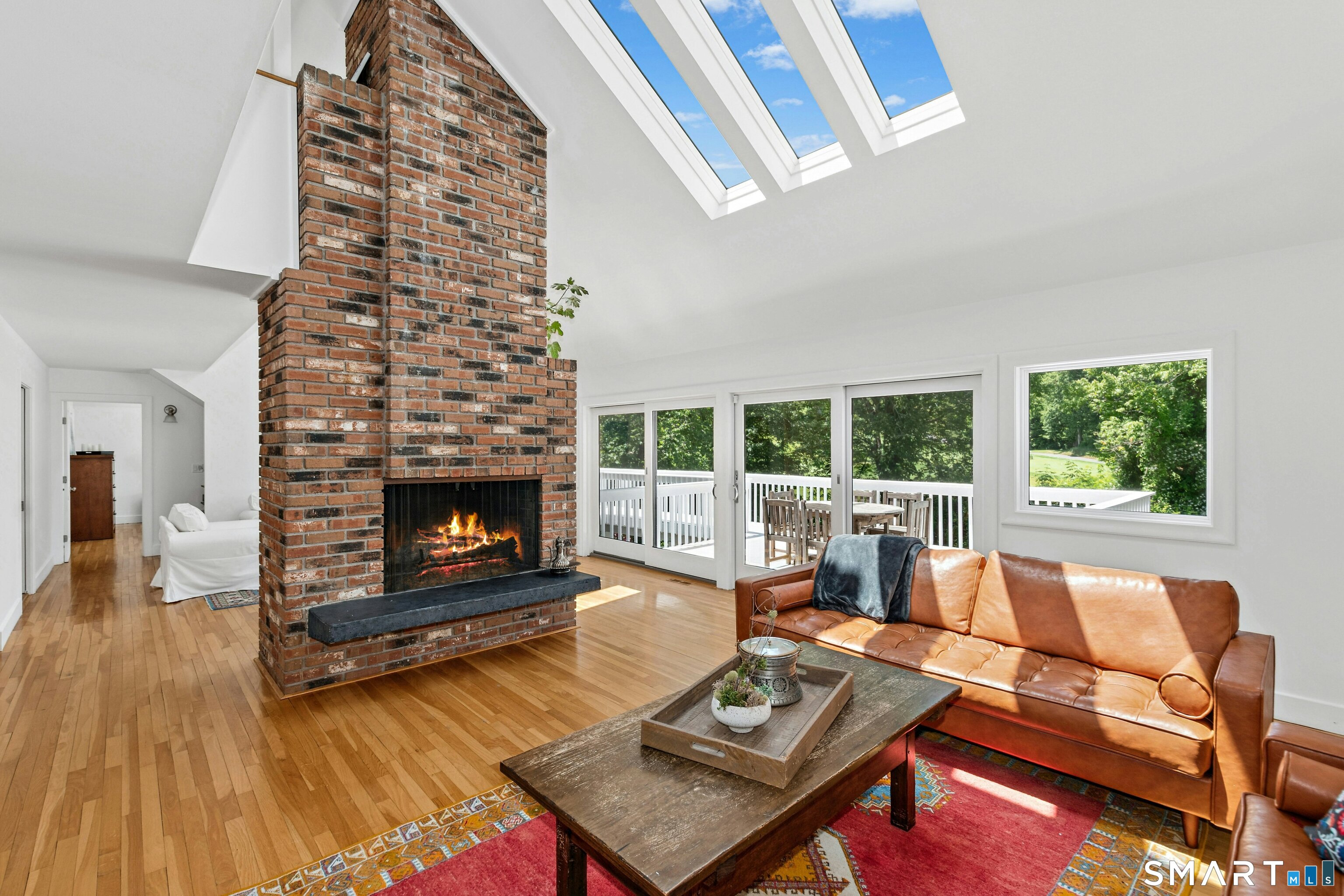 38 Old Redding Road Weston, CT 06883 - Photo 5 of 40 Upon entry the home unfolds with a layout featuring vaulted ceilings, skylights, walls of glass, rich wood floors, and fireplaces that add charm and character.