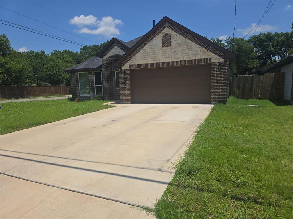 562 Jonelle Avenue Dallas, TX 75217 - Photo 2 of 20 French country home with a garage, driveway, and brick siding