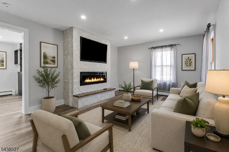 83 Highway 15 Lafayette, NJ 07848 - Photo 2 of 20 a living room with furniture a flat screen tv and a fireplace