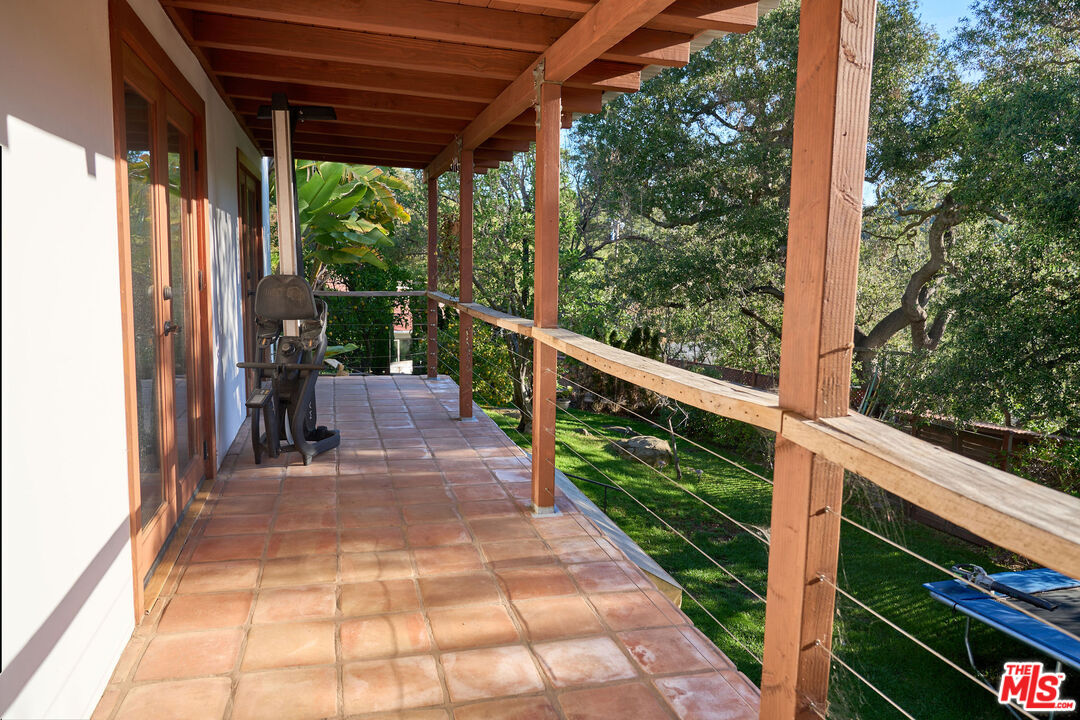 22068 Topanga School Road Topanga, CA 90290 - Photo 31 of 70 a view of a patio with wooden floor and roof with a garden view