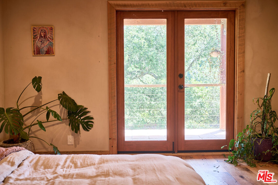 22068 Topanga School Road Topanga, CA 90290 - Photo 34 of 70 a view of a bedroom with a large bed and a large window