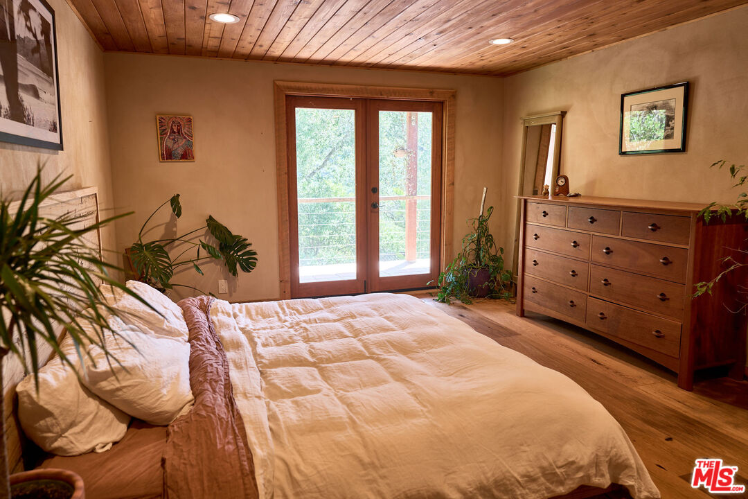 22068 Topanga School Road Topanga, CA 90290 - Photo 36 of 70 a bedroom with a bed and a dresser