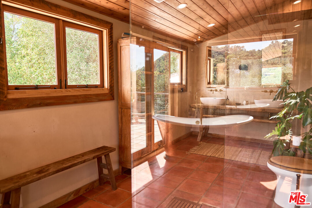 22068 Topanga School Road Topanga, CA 90290 - Photo 39 of 70 a living room with furniture and floor to ceiling windows