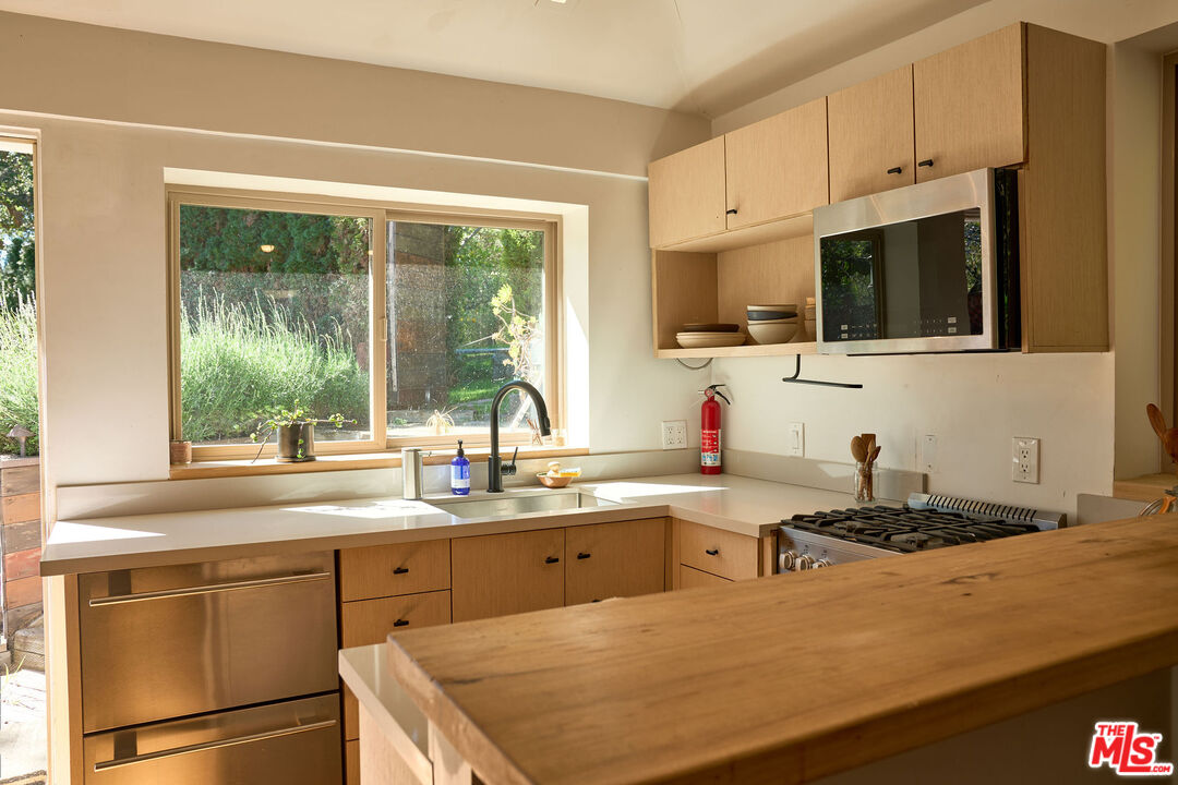 22068 Topanga School Road Topanga, CA 90290 - Photo 45 of 70 a kitchen with stainless steel appliances granite countertop a sink stove and microwave