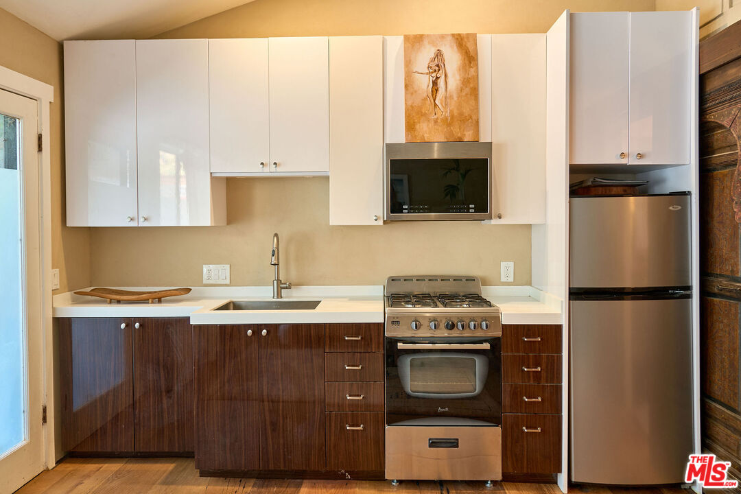 22068 Topanga School Road Topanga, CA 90290 - Photo 51 of 70 a kitchen with stainless steel appliances granite countertop a stove a refrigerator and a sink