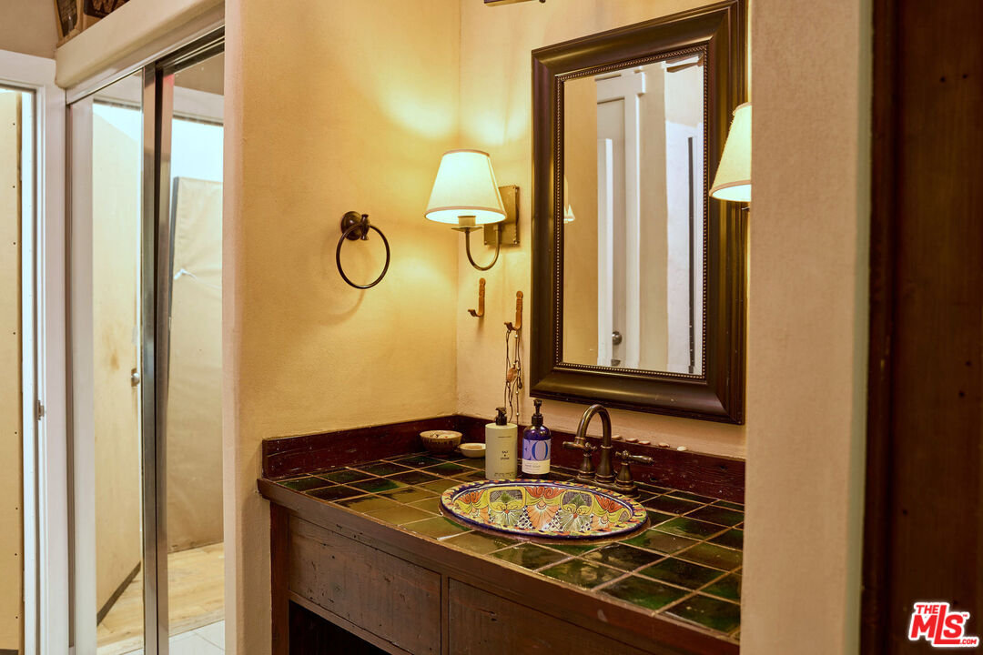 22068 Topanga School Road Topanga, CA 90290 - Photo 52 of 70 a bathroom with a granite countertop sink and a mirror