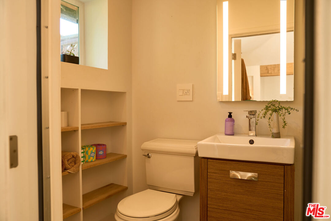 22068 Topanga School Road Topanga, CA 90290 - Photo 53 of 70 a bathroom with a sink a toilet and mirror