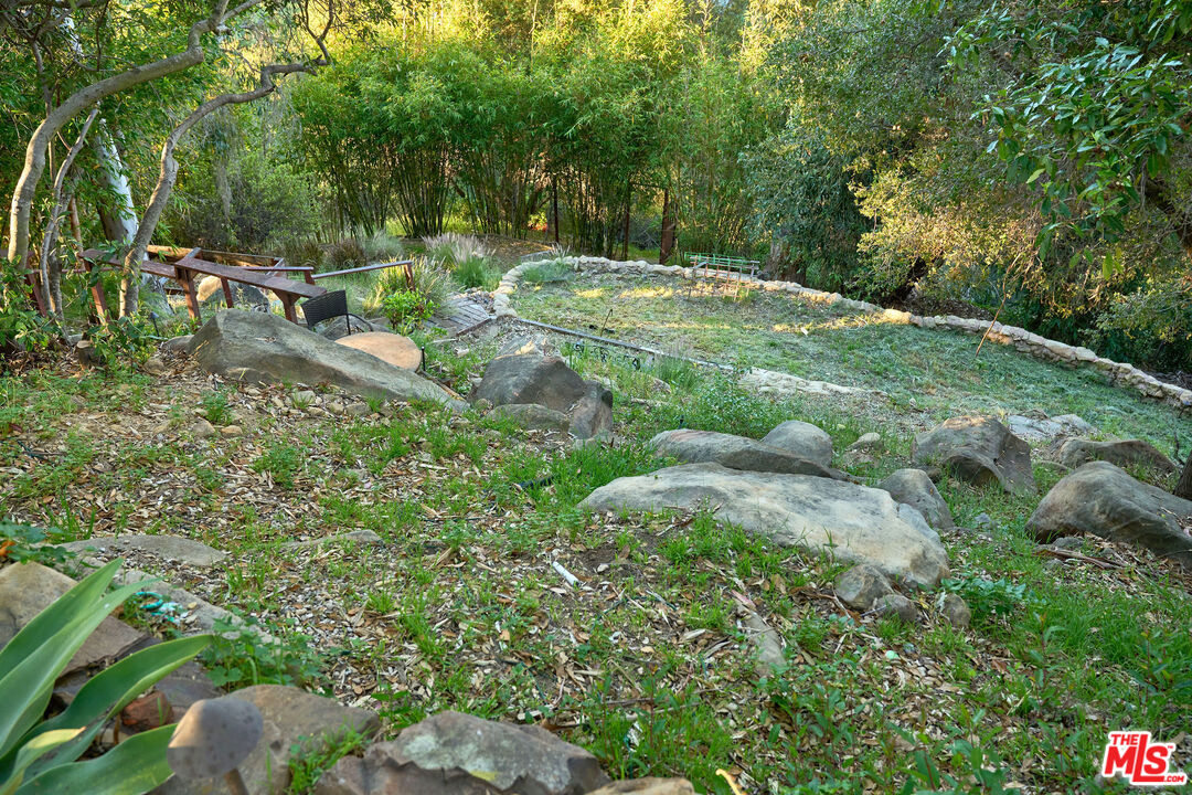 22068 Topanga School Road Topanga, CA 90290 - Photo 59 of 70 a backyard of a house with a yard and outdoor seating