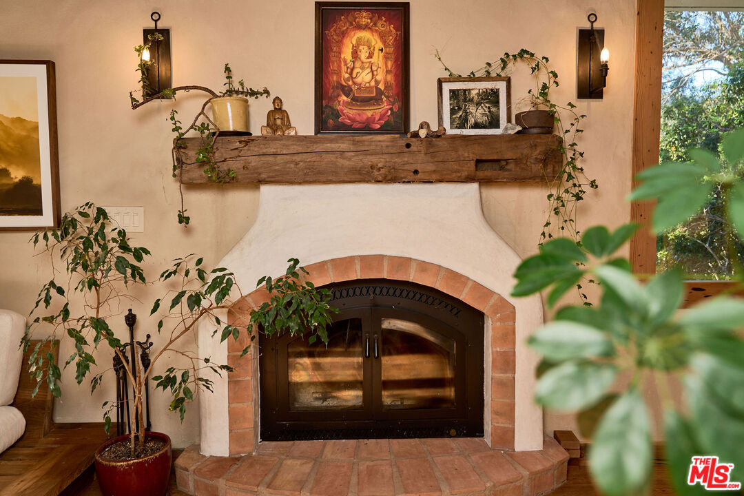 22068 Topanga School Road Topanga, CA 90290 - Photo 6 of 70 a living room with a fireplace and potted plants