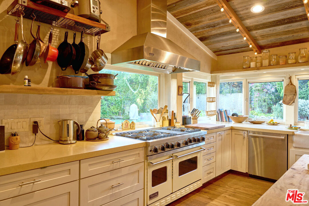 22068 Topanga School Road Topanga, CA 90290 - Photo 10 of 70 a kitchen with stainless steel appliances a stove a sink and a cabinets