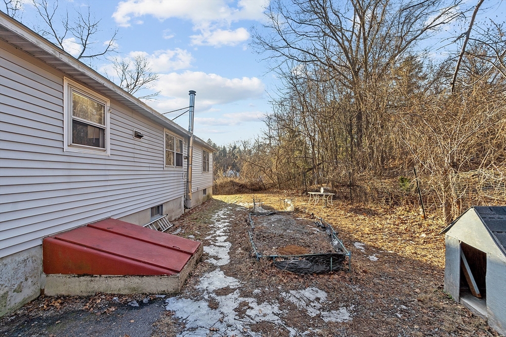 5 Catherine Street Clinton, MA 01510 - Photo 27 of 29 a backyard of a house with oven and wooden fence