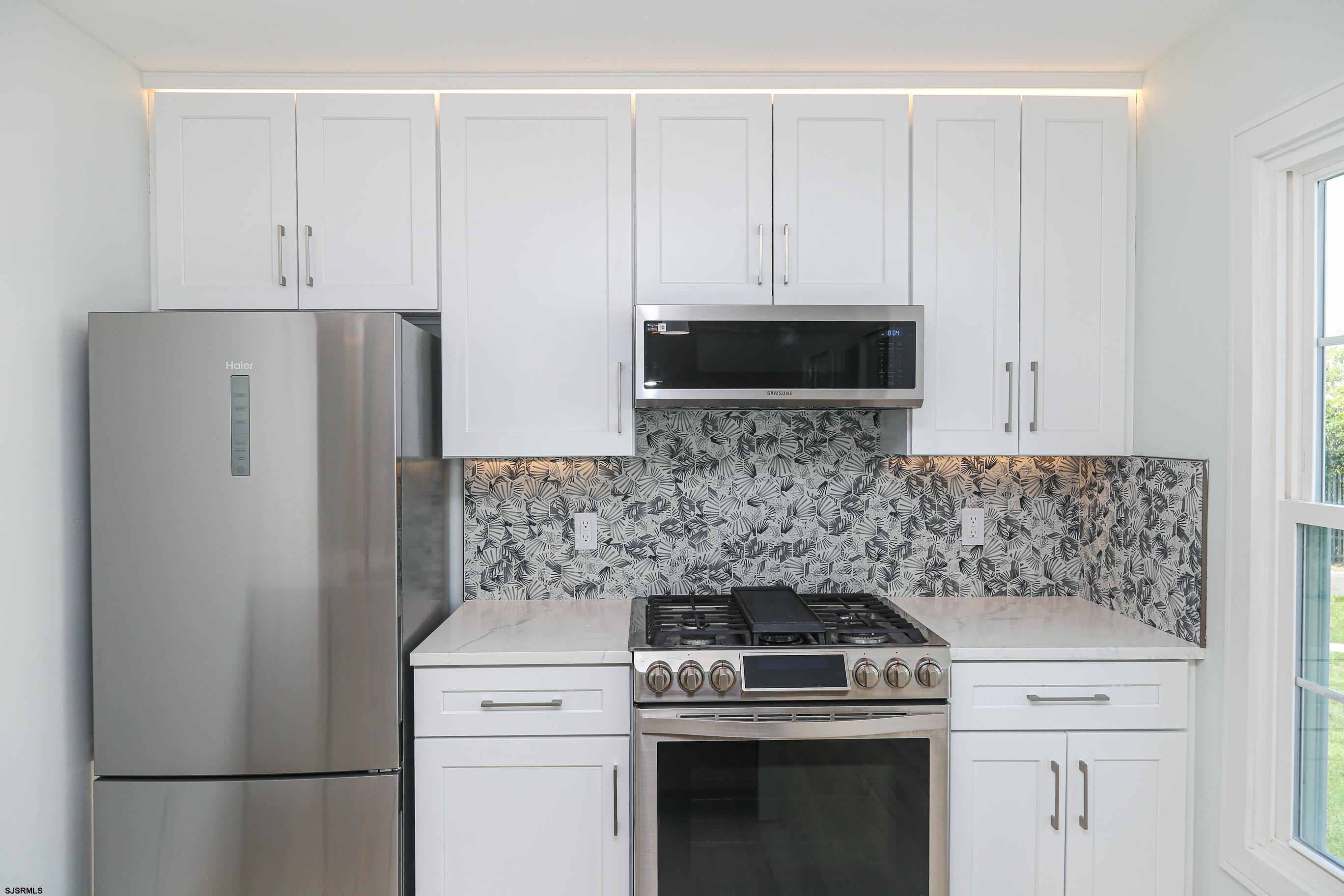 169 40th Street South, Unit 38 Brigantine, NJ 08203 - Photo 12 of 79 a stove top oven sitting inside of a kitchen