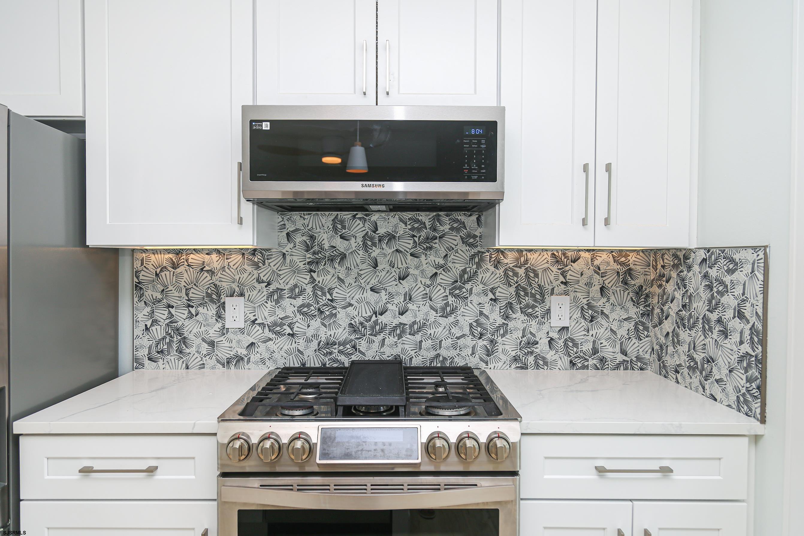169 40th Street South, Unit 38 Brigantine, NJ 08203 - Photo 16 of 79 a stove top oven sitting inside of a kitchen