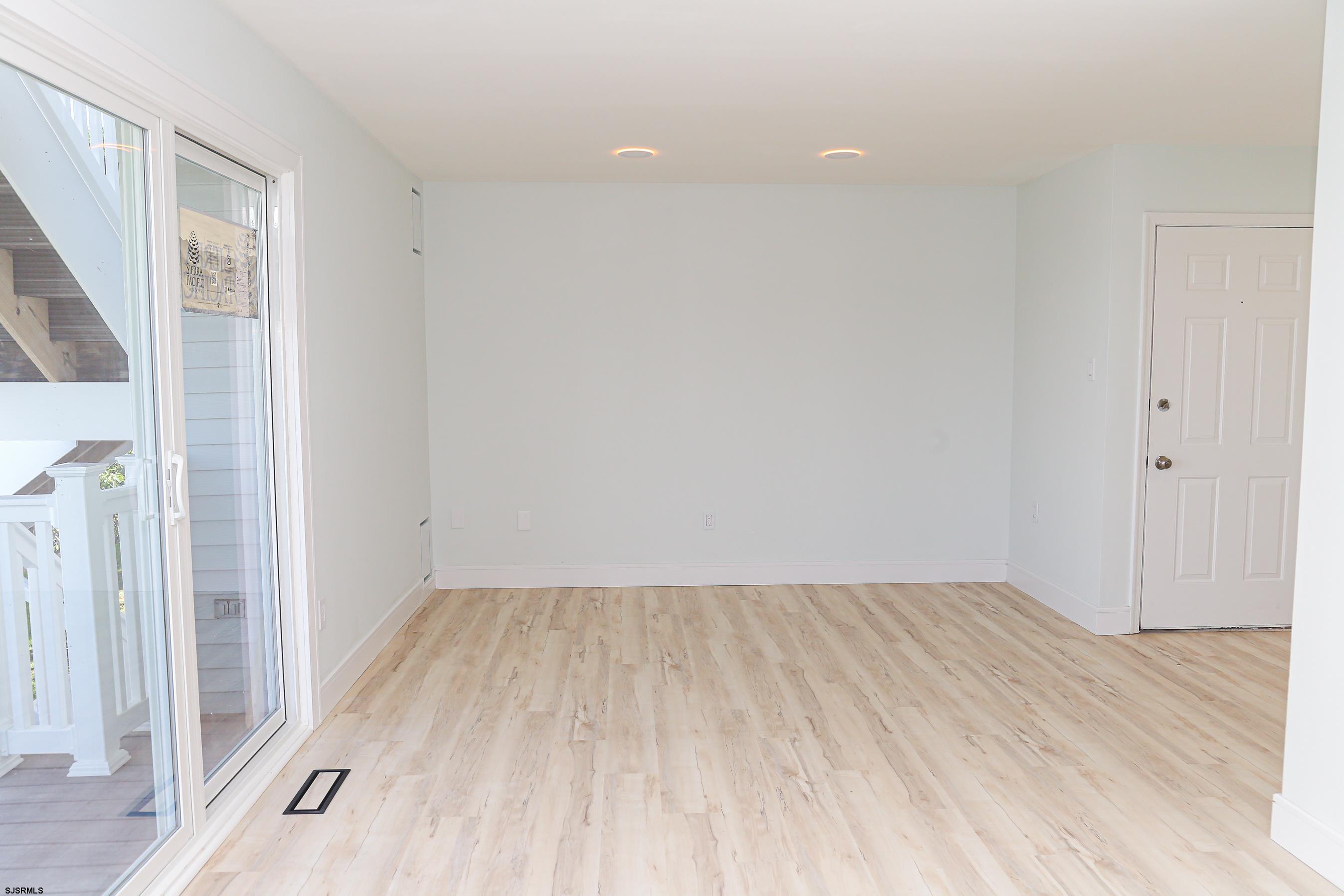 169 40th Street South, Unit 38 Brigantine, NJ 08203 - Photo 26 of 79 a view of an empty room with wooden floor and a window