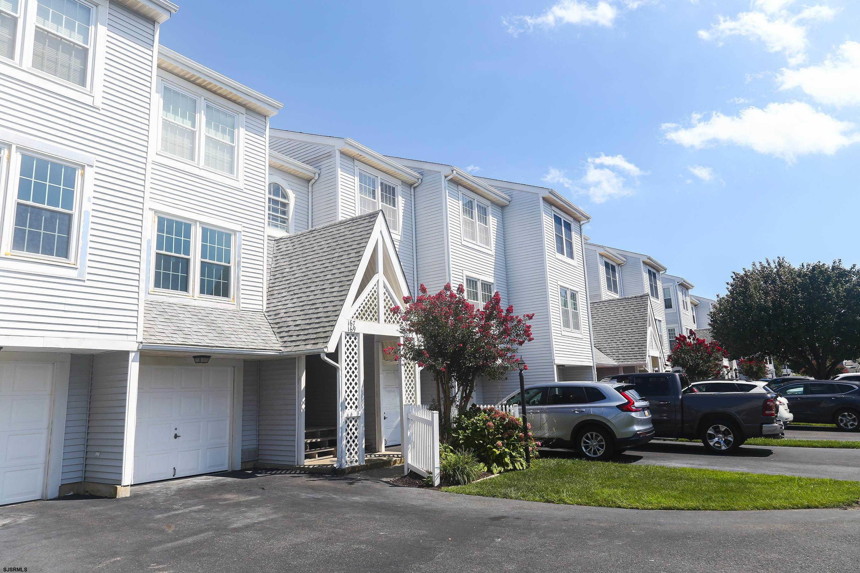 169 40th Street South, Unit 38 Brigantine, NJ 08203 - Photo 3 of 79 a car parked in front of a white house