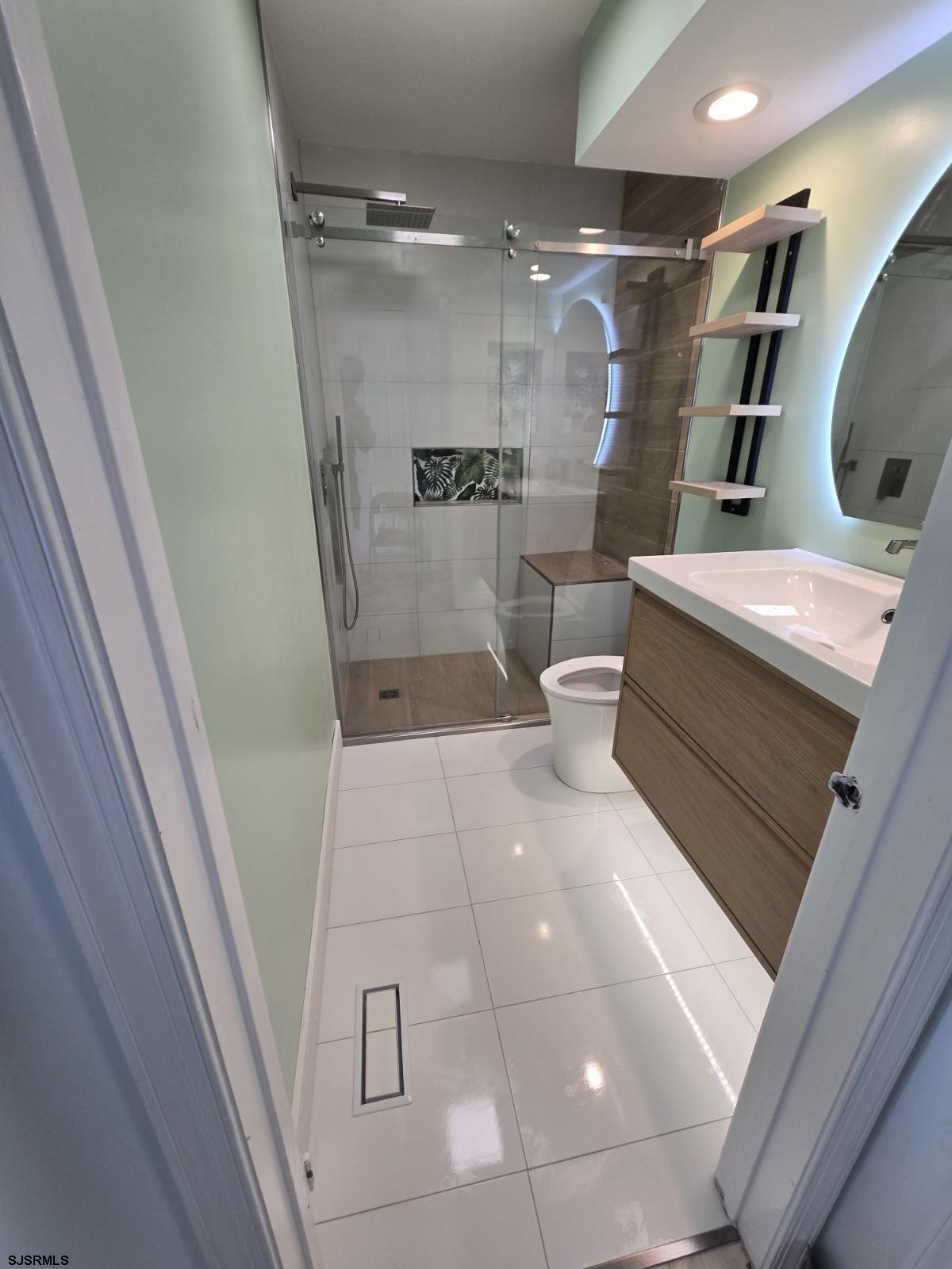 169 40th Street South, Unit 38 Brigantine, NJ 08203 - Photo 40 of 79 a bathroom with a bathtub and a shower