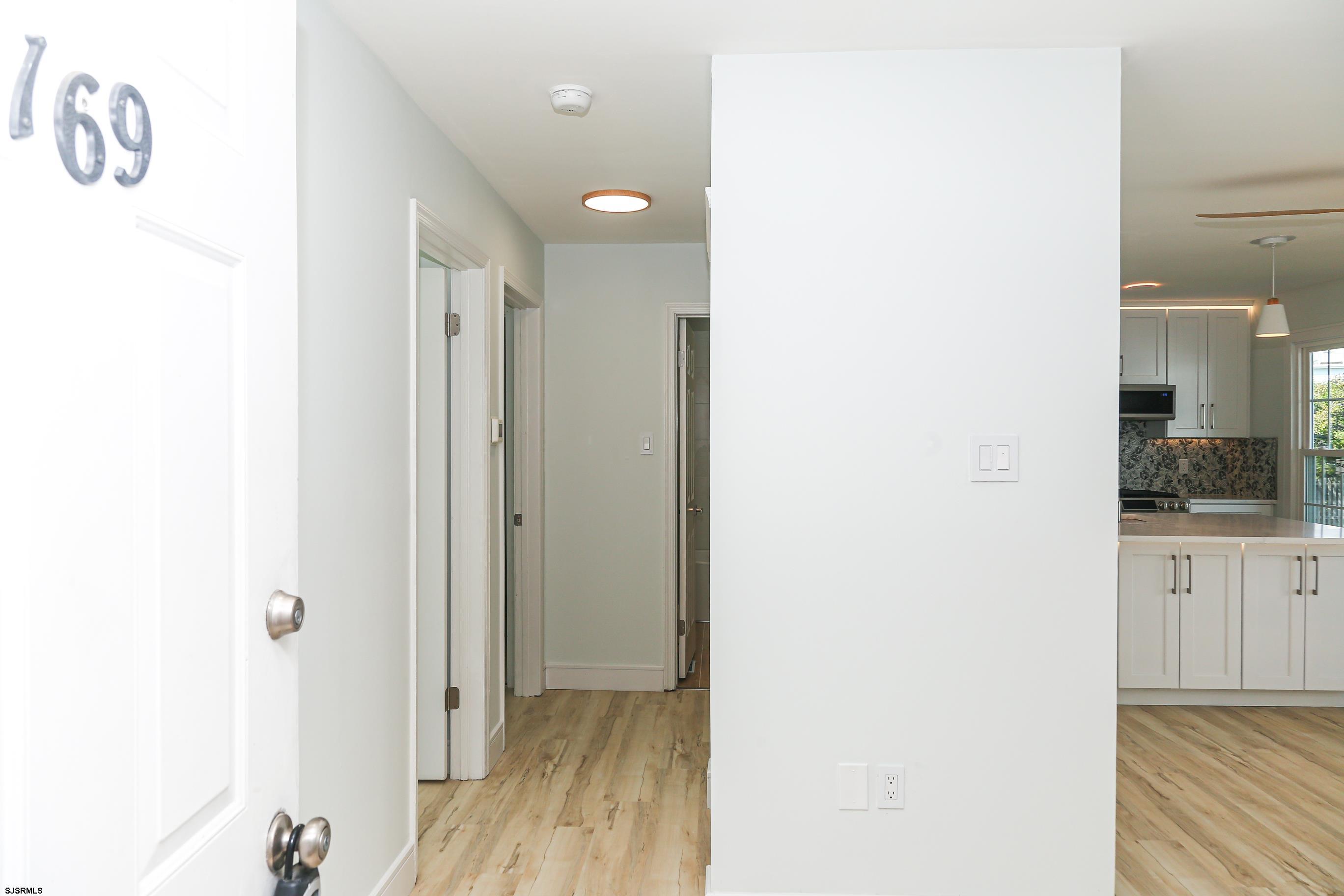 169 40th Street South, Unit 38 Brigantine, NJ 08203 - Photo 4 of 79 a view of hallway with wooden floor