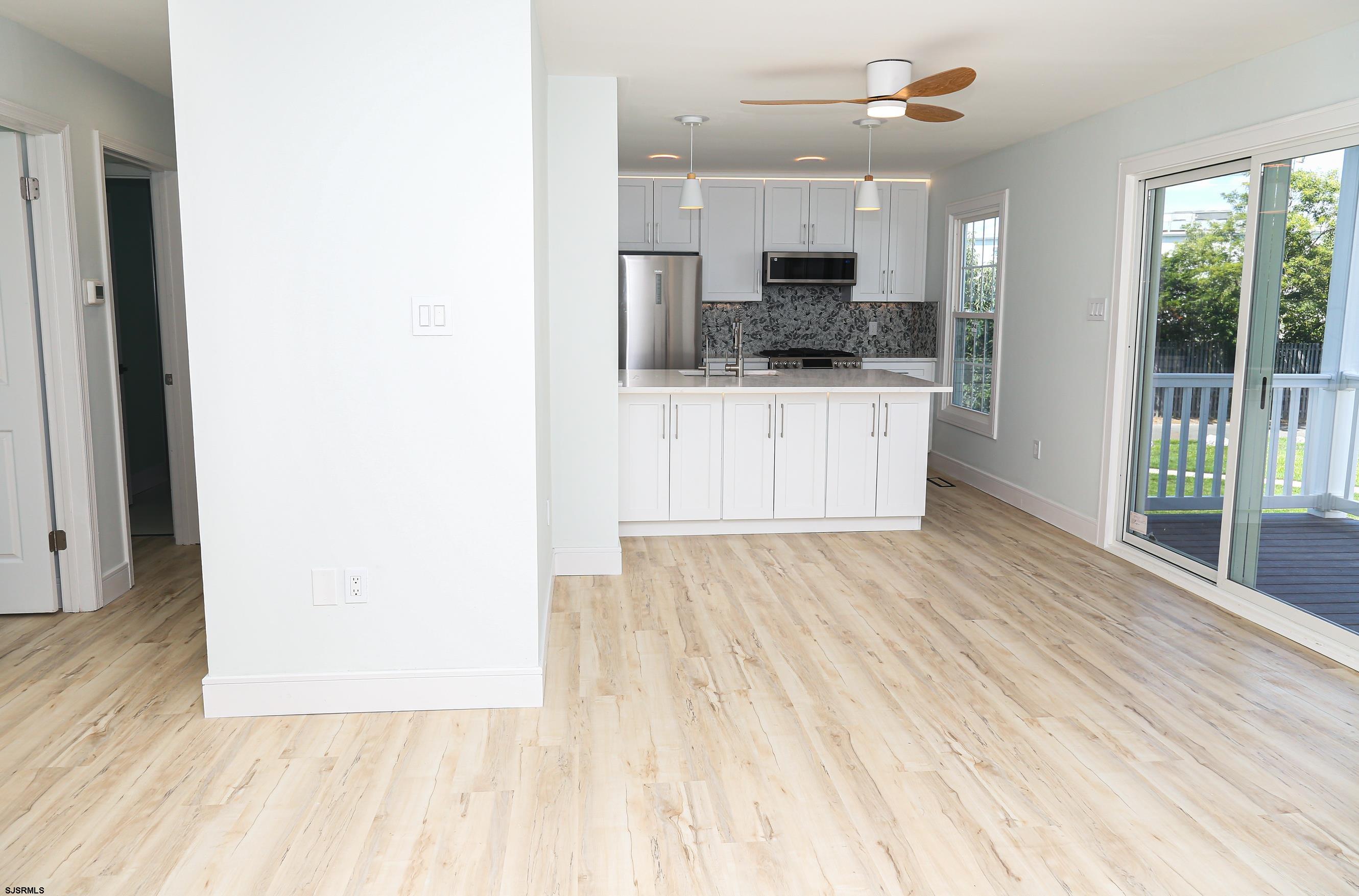 169 40th Street South, Unit 38 Brigantine, NJ 08203 - Photo 5 of 79 a view of kitchen with granite countertop cabinets and outdoor space
