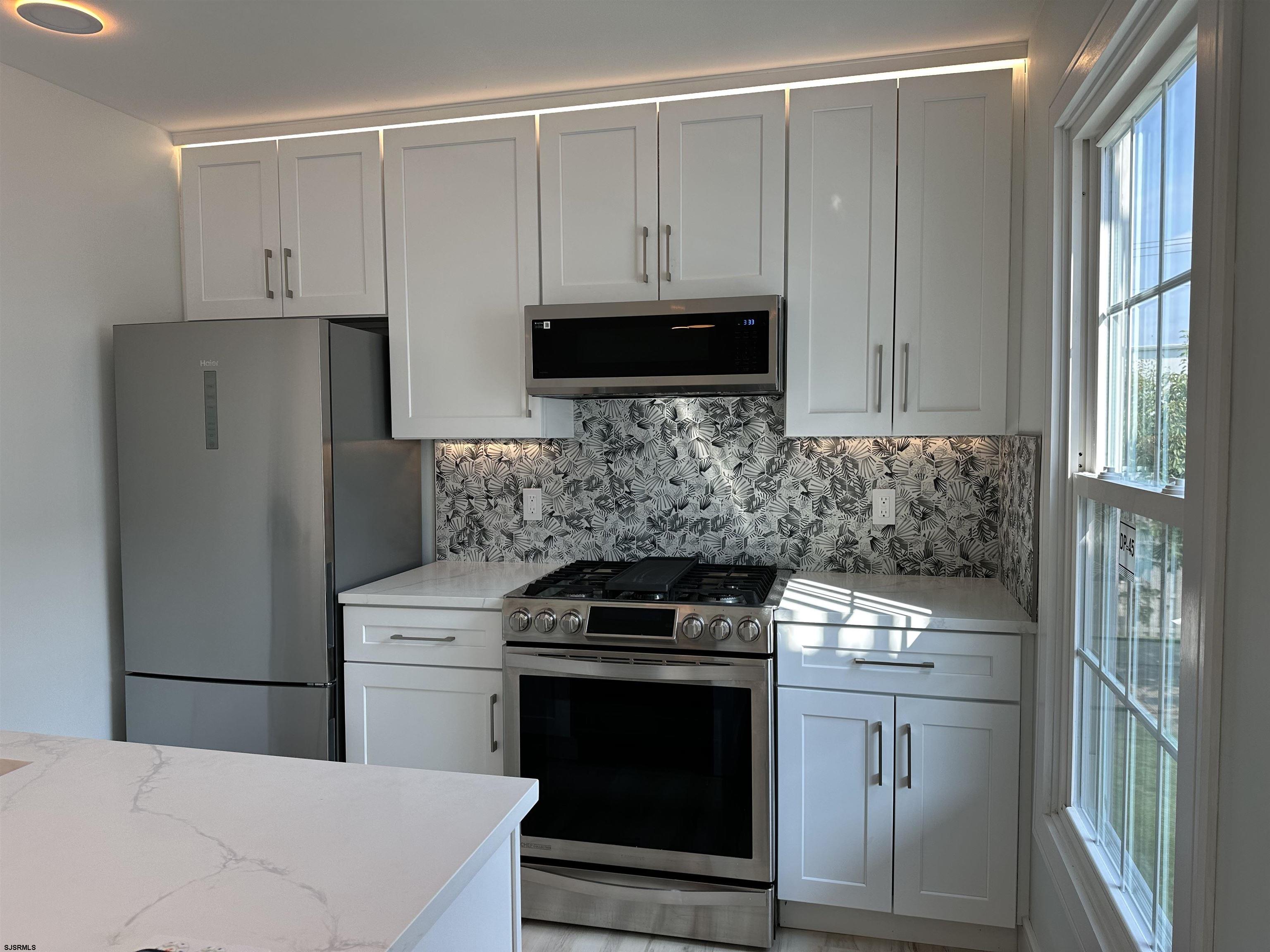 169 40th Street South, Unit 38 Brigantine, NJ 08203 - Photo 51 of 79 a kitchen with cabinets stainless steel appliances and a counter space