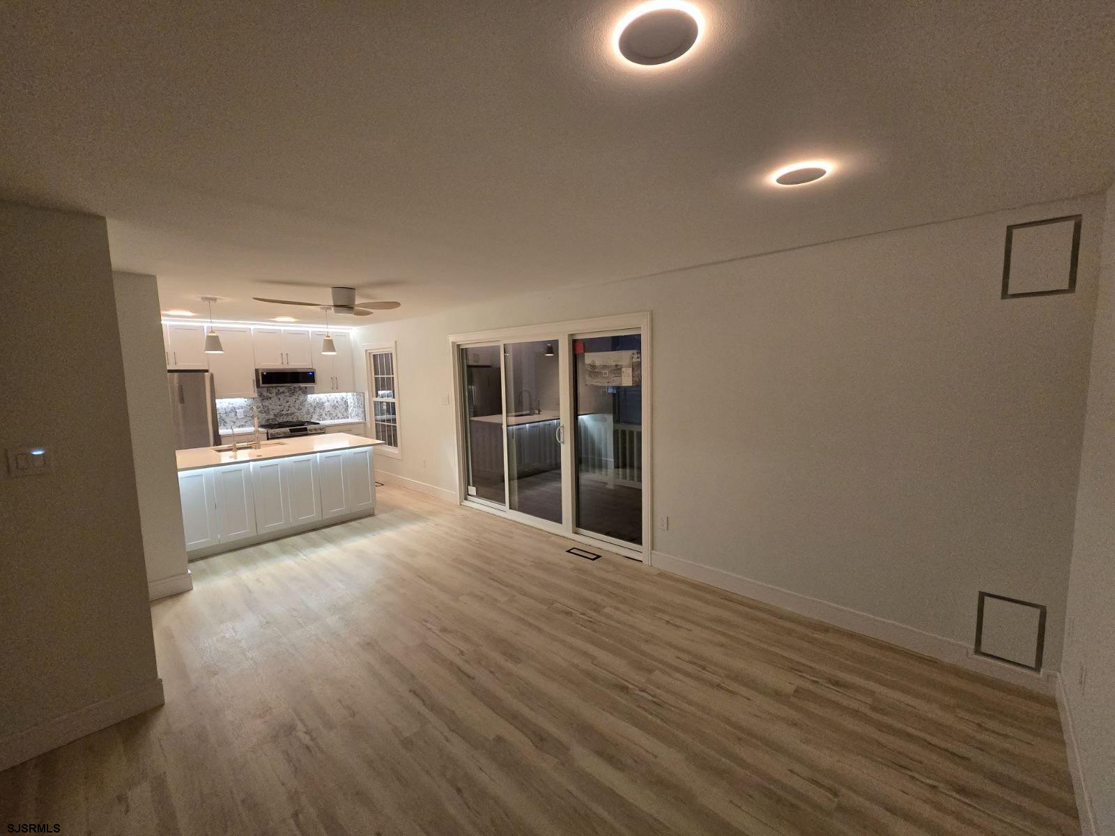 169 40th Street South, Unit 38 Brigantine, NJ 08203 - Photo 55 of 79 a view of a kitchen with a sink and dishwasher a refrigerator with wooden floor